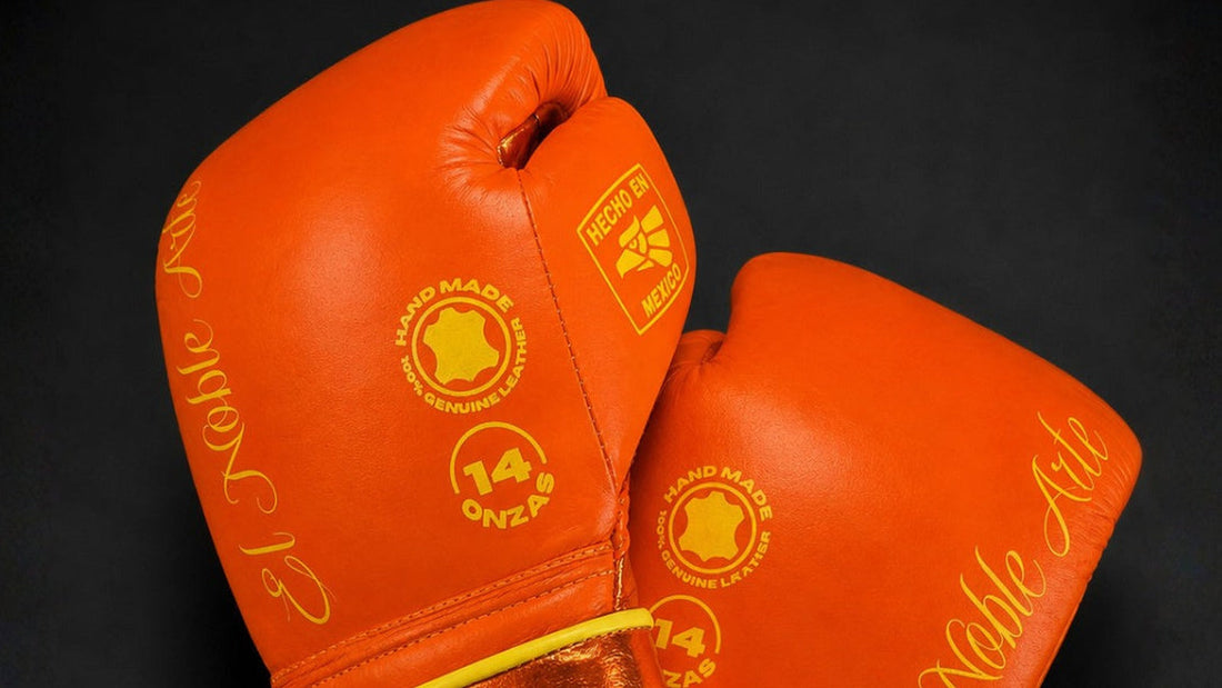 Detalle de la piel naranja y los bordados de unos guantes Guanajuato Teja Coral de 14 onzas